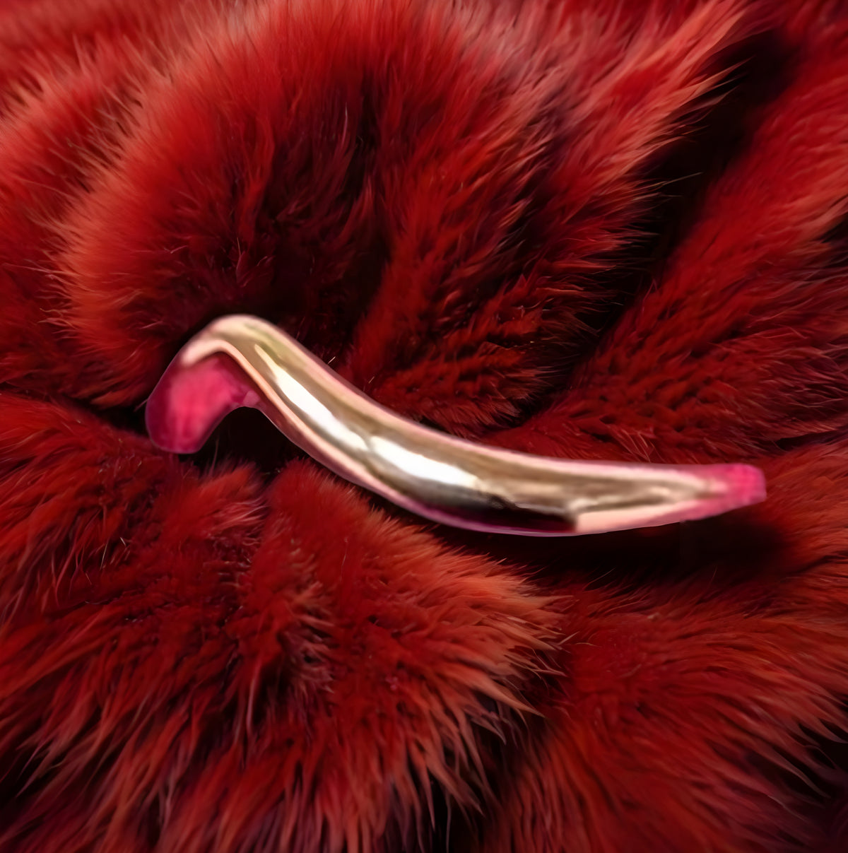 Pink and silver hair clip on a red fur background