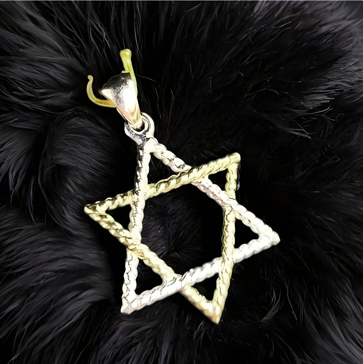Gold and silver David's star-shaped pendant on a black furry background