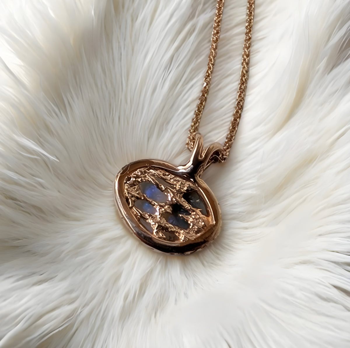 Golden necklace with a heart-shaped pendant on a white fur background