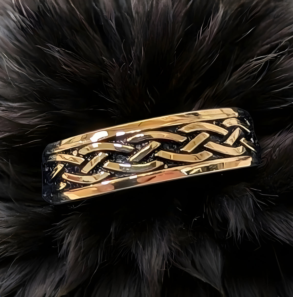 Gold braided hair clip on a black fur background