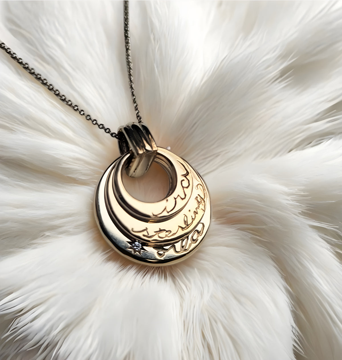Gold necklace with a circular pendant on a white fur background